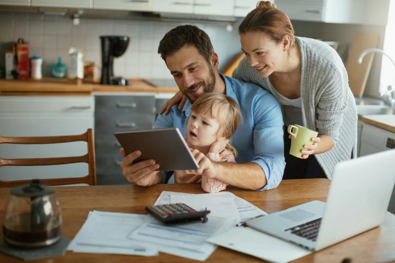 Person reviewing tax forms with a calculator